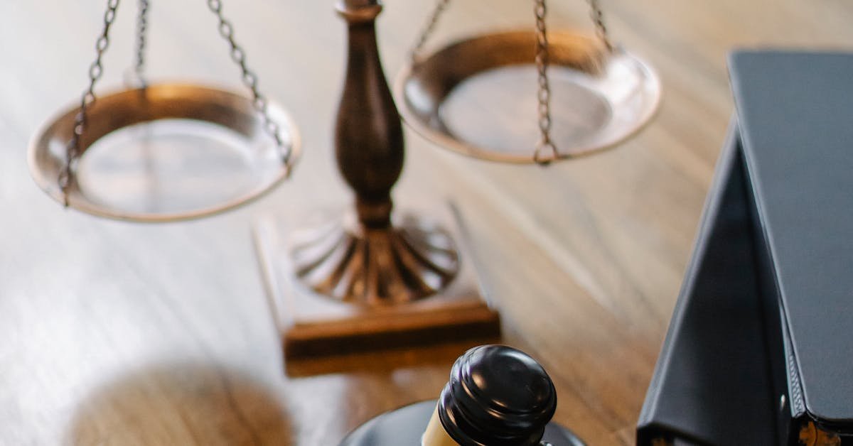 Legal scales and gavel on a desk representing commercial lease obligations and surveyor legal responsibilities