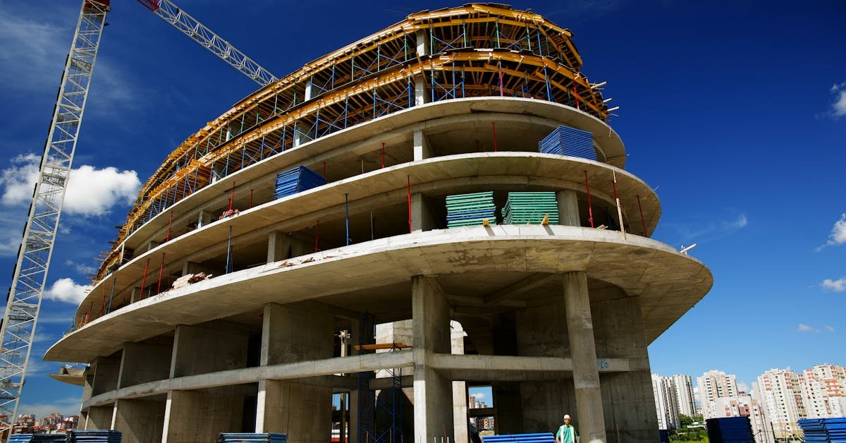 Multi-storey commercial building under construction with exposed structural elements, illustrating the types of defects found in commercial building surveys