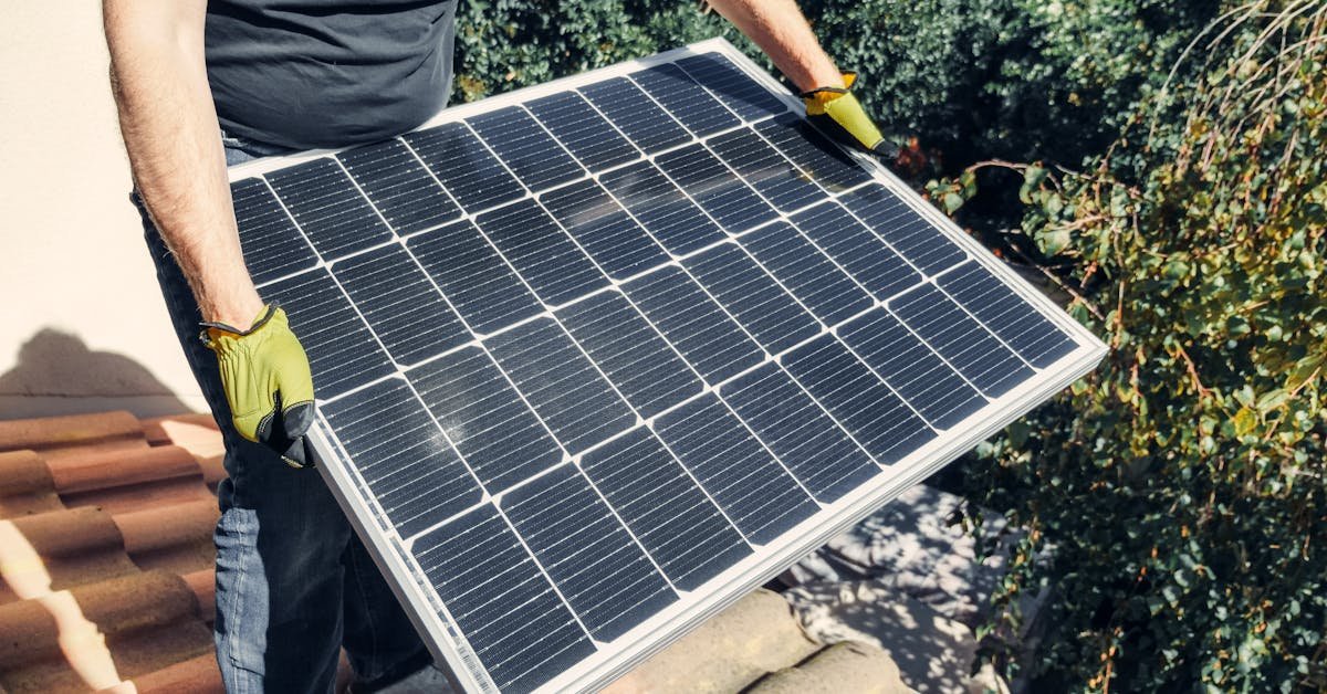 Worker with gloves holding a solar panel representing energy efficiency and EPC ratings for commercial properties
