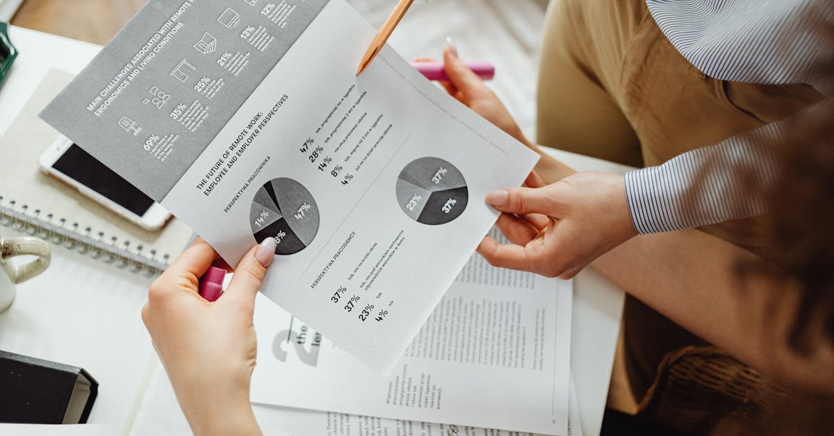 Two professionals reviewing a commercial building survey report together, pointing at charts and written findings