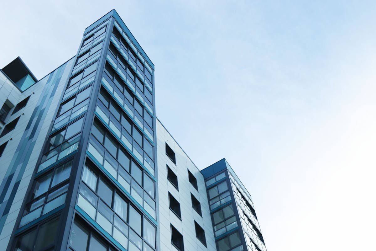 Modern multi-storey commercial glass office building — the type of commercial property inspected during a full commercial building survey