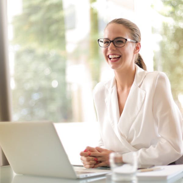 Rebecca Thornton, Senior Commercial Building Surveyor, smiling and holding a tablet in a UK commercial lobby