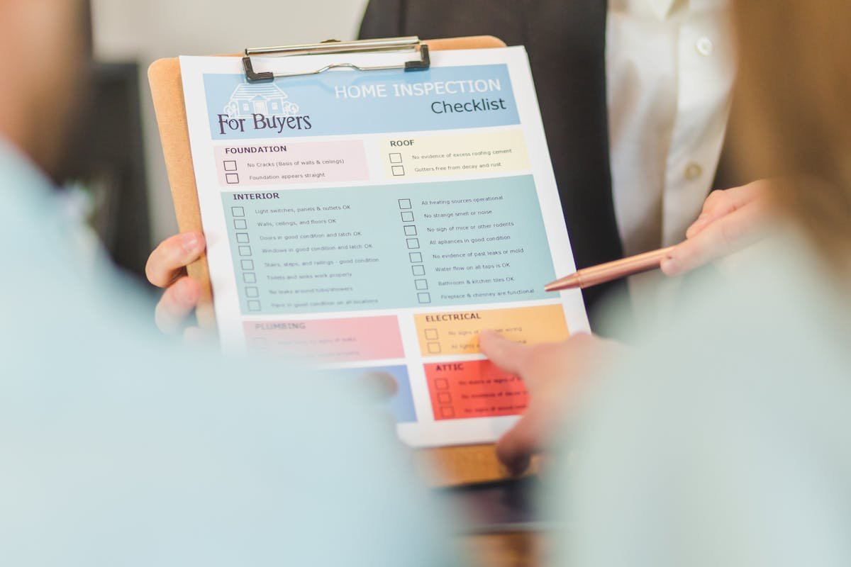 Building inspector holding a clipboard with a property condition checklist, documenting the state of a commercial property for a schedule of condition report