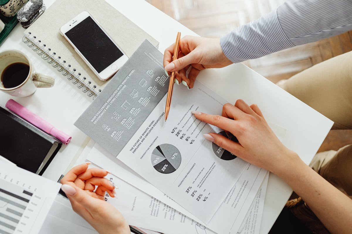 Commercial property professionals reviewing technical due diligence reports, charts and data at a desk — investment risk assessment for a UK commercial property acquisition
